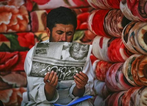 A man selling carpets reads a local newspaper reporting the death of al-Qaeda leader Osama bin Laden in Quetta May 2, 2011. Bin Laden was killed in a US helicopter raid on a mansion near the Pakistani capital Islamabad early on Monday, officials said, ending a nearly 10-year worldwide hunt for the mastermind of the Sept. 11 attacks. U.S. officials said bin Laden was found in the million-dollar compound in the military garrison town of Abbottabad, 60 km (35 miles) north of Islamabad.[ Snapshot: The world in 24 hours