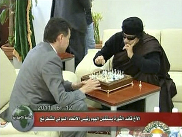 Libyan leader Muammar Gadhafi plays chess with Kirsan Ilyumzhinov, the president of the international chess federation, in Tripoli on June 12, 2011 in this still image taken from video broadcast on Libyan state television. Gadhafi plays chess with int'l chess federation president