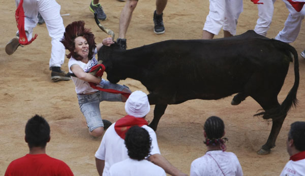 A heifer charges at a reveller at Pamplona's bullring after the sixth running of the bulls at the San Fermin festival in Pamplona July 12, 2011. Bulls run at San Fermin festival