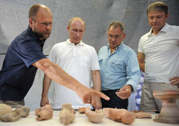 Russian Prime Minister Vladimir Putin (2nd L), Emergencies Minister Sergei Shoigu (2nd R), and Krasnodar region Governor Alexander Tkachev (R) are shown a variety of relics by Doctor Vladimir Kuznetzov at an archaeological dig on the Taman peninsular in southern Russia August 10, 2011. Versatile Putin dives to recover relics