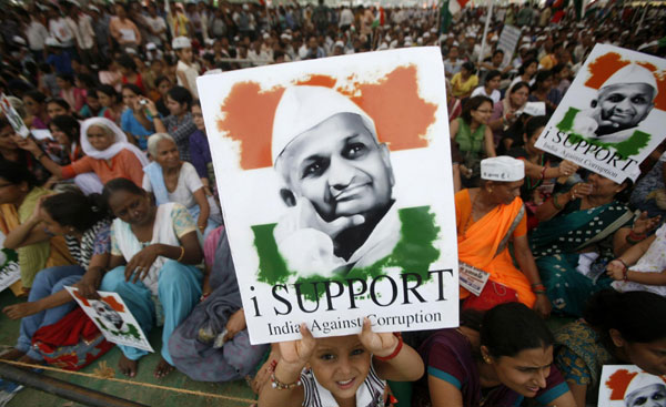 A child holds a portrait of Anna Hazare on the fourth day of the social activist's fast at the Ramlila grounds in New Delhi in this August 20, 2011 file photo Anti-graft campaign awakens India's middle class