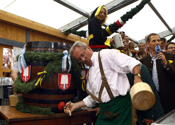 Munich Mayor Christian Ude taps the first barrel of beer during the opening ceremony for the 178th Oktoberfest in Munich September 17, 2011. World's biggest beer fest opens in Munich