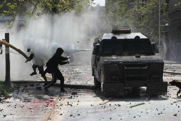A riot police vehicle releases tear gas on demonstrators during a student rally against the government's public education system in Santiago city September 22, 2011. Chile: Students riot demanding education reform