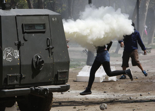 A riot police vehicle releases tear gas at demonstrators during a student rally against the government's public education system in Santiago city September 22, 2011. Chile: Students riot demanding education reform