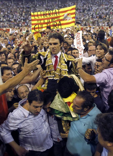 Spanish bullfighter Jose Tomas is carried on shoulders by fans after the last bullfight at Monumental bullring in central Barcelona Sept 25, 2011. Fans mourn, opponents celebrate last bullfight