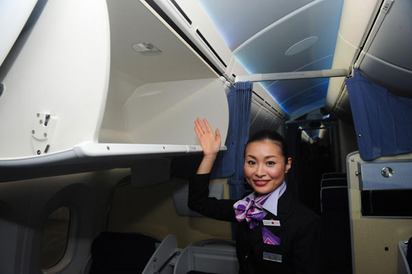 An air hostess introduces All Nippon Airways' (ANA) first Boeing 787 Dreamliner aircraft which landed at Haneda airport in Tokyo Sept 28, 2011. A look inside the New Boeing 787 Dreamliner