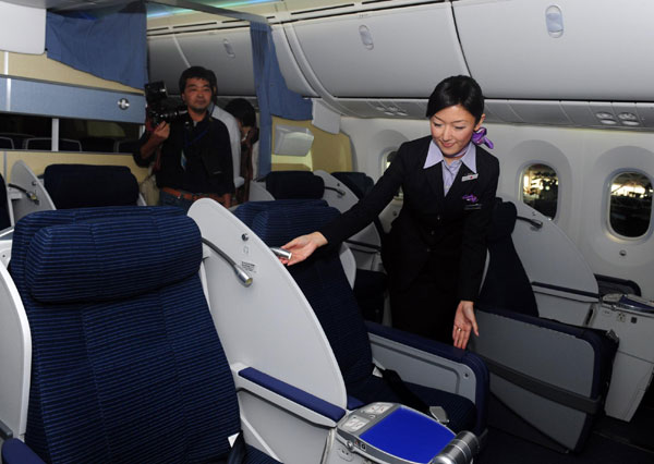 An air hostess introduces All Nippon Airways' (ANA) first Boeing 787 Dreamliner aircraft which landed at Haneda airport in Tokyo Sept 28, 2011. A look inside the New Boeing 787 Dreamliner