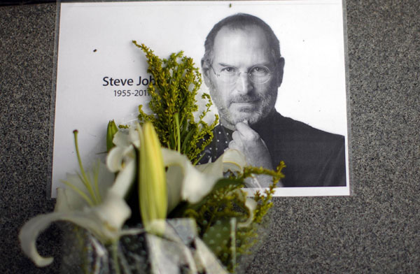 Flowers for Apple co-founder Steve Jobs are seen outside an Apple Store in downtown Shanghai October 6, 2011. The world mourns Steve Jobs