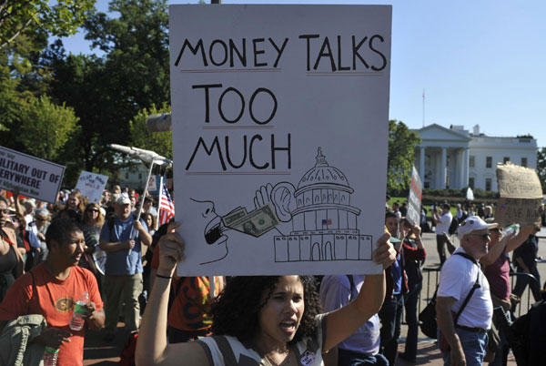 A protestor holds a placard during an 'Occupy D.C.' movement in downtown Washington D.C., capital of the United States, Oct 6, 2011. US 'occupied' by protestors