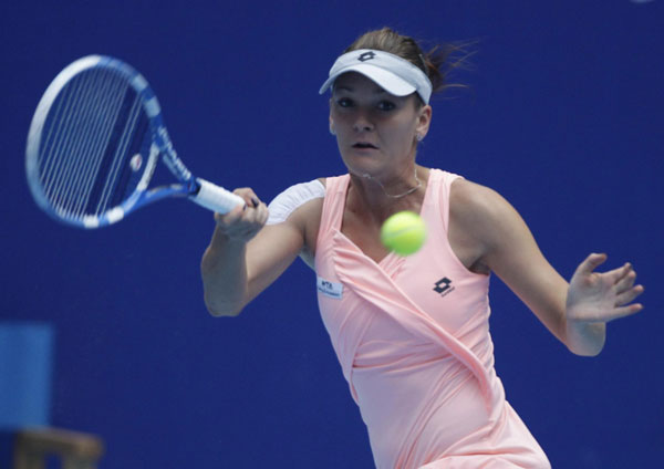 Agnieszka Radwanska of Poland returns the ball to Ana Ivanovic of Serbia during their quarter-final match in the China Open tennis tournament at the National Tennis Center in Beijing October 7, 2011. Ivanovic sends Radwanska to China Open semis