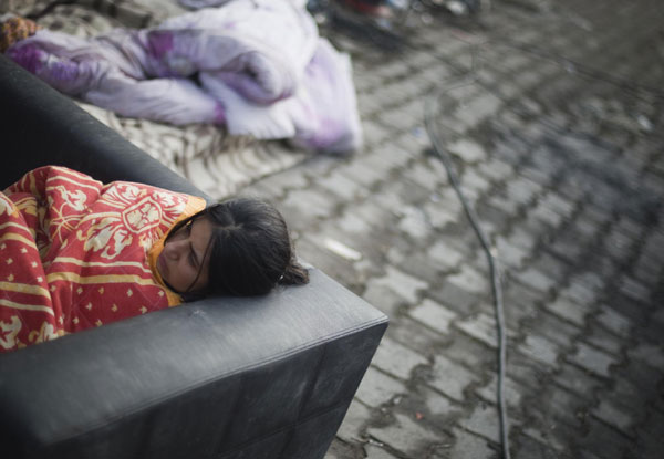 A woman affected by the earthquake rests at the corner of a street in Ercis Oct 26, 2011. Turkey struggled to provide shelter on Wednesday to tens of thousands left homeless by an earthquake that killed nearly 500, and rescue teams began taking painful decisions to call off searches for those buried alive. Turkey struggles to shelter people after quake