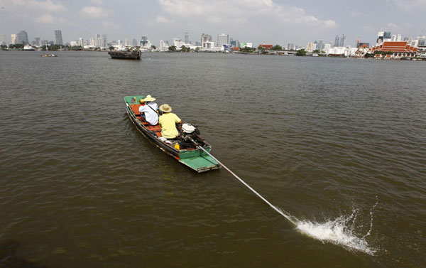 People travel on a boat on the Chao Phraya river in Bangkok Oct 31, 2011. Thailand hopes flooded industrial estates back up