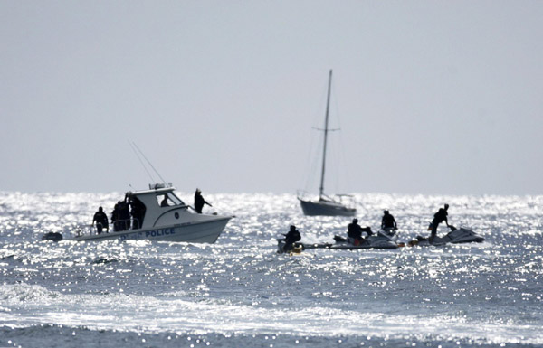 A police boat and police officers on jet skis leave Ala Moana boat harbor on a patrol of the coastline during APEC week in Honolulu, Hawaii November 9, 2011. Security tight in Honolulu ahead of APEC