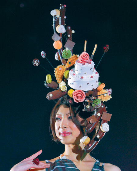 A model displays a headpiece made of confectionery by Japanese patssier Rie Taniminchi during the Tokyo Sweets Collection in Tokyo on Wednesday. Sweet hat for Tokyo Sweets Collection