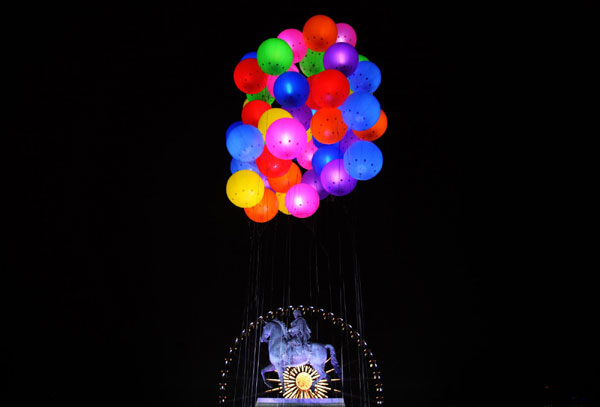 The statue of French King Louis XIV is seen under balloons filled with lights during the Festival of Lights in Lyon, France, Dec 11, 2011. Festival of Lights marked in Lyon