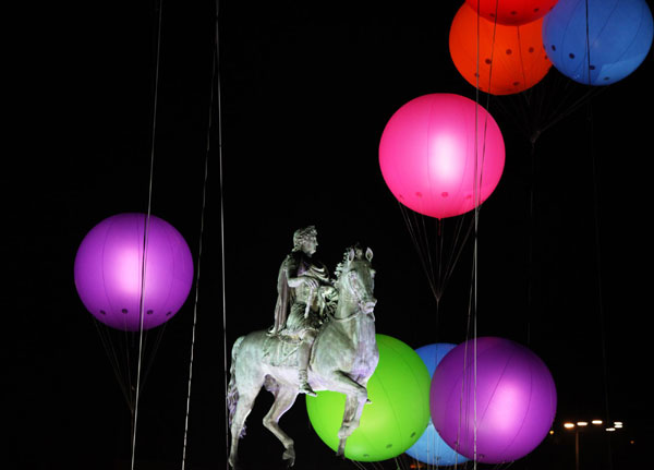 The statue of French King Louis XIV is seen under balloons filled with lights during the Festival of Lights in Lyon, France, Dec 11, 2011. Festival of Lights marked in Lyon