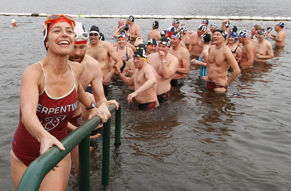 Members of the Serpentine Swimming Club leave the water after the annual Peter Pan Cup handicap race on Christmas Day in Hyde Park in London December 25, 2011. Peter Pan Cup handicap race in London