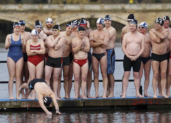 Members of the Serpentine Swimming Club wait to enter the water for the annual Peter Pan Cup handicap race on Christmas Day in Hyde Park in London December 25, 2011. Peter Pan Cup handicap race in London