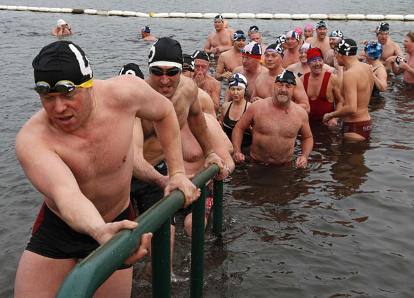 Members of the Serpentine Swimming Club leave the water after the annual Peter Pan Cup handicap race on Christmas Day in Hyde Park in London December 25, 2011. The race has been held every year since 1864, and in 1904 novelist J.M. Barrie presented the first annual Peter Pan Cup to the event's winner. Peter Pan Cup handicap race in London