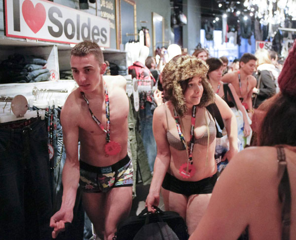 Shoppers in their underwear search for items at a Desigual store in Lyon January 11, 2012. Shoppers in underwear for free clothes in Lyon