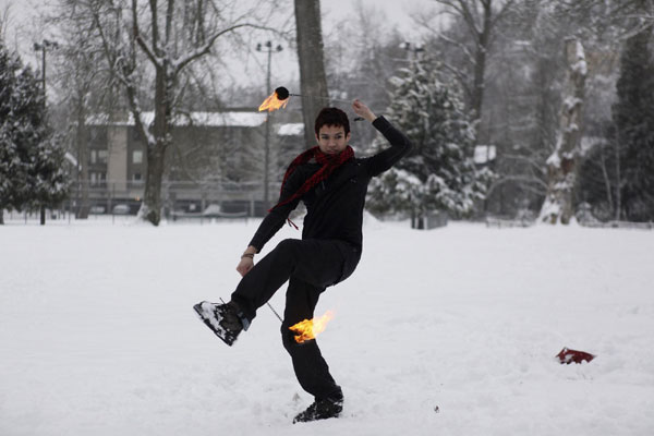 Keenan Pischke practices fire poi in Kirkland, Washington January 18, 2012. Washington braced for epic snowstorm
