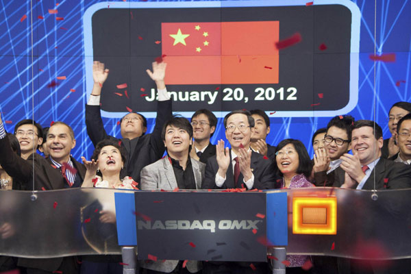 Chinese Ambassador Sun Guoxiang (middle R) and pianist Lang Lang ring the NASDAQ Stock Market Opening Bell in celebration of Chinese New Year in New York January 20, 2012 in this NASDAQ handout photo. NASDAQ opening bell hails Chinese New Year