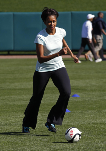 US first lady Michelle Obama plays mini-tennis during a 'Let's Move!' faith and communities physical activity at Disney World's ESPN Wide World of Sports in Orlando, Florida. 'Let's Move' with US first lady