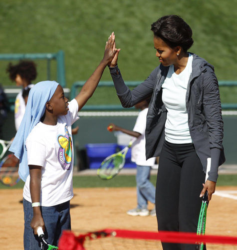 US first lady Michelle Obama plays mini-tennis during a 'Let's Move!' faith and communities physical activity at Disney World's ESPN Wide World of Sports in Orlando, Florida. 'Let's Move' with US first lady