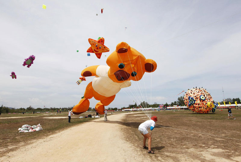 France's Frederique Riquier flies her kite during the Cha-Am International Kite Festival at the Thai resort beach town of Cha-Am, 160 km (99 miles) southwest of Bangkok, March 10, 2012. The three days event held to promote Thailand tourism annually from March 9-11. Kite festival kicks off in Thailand