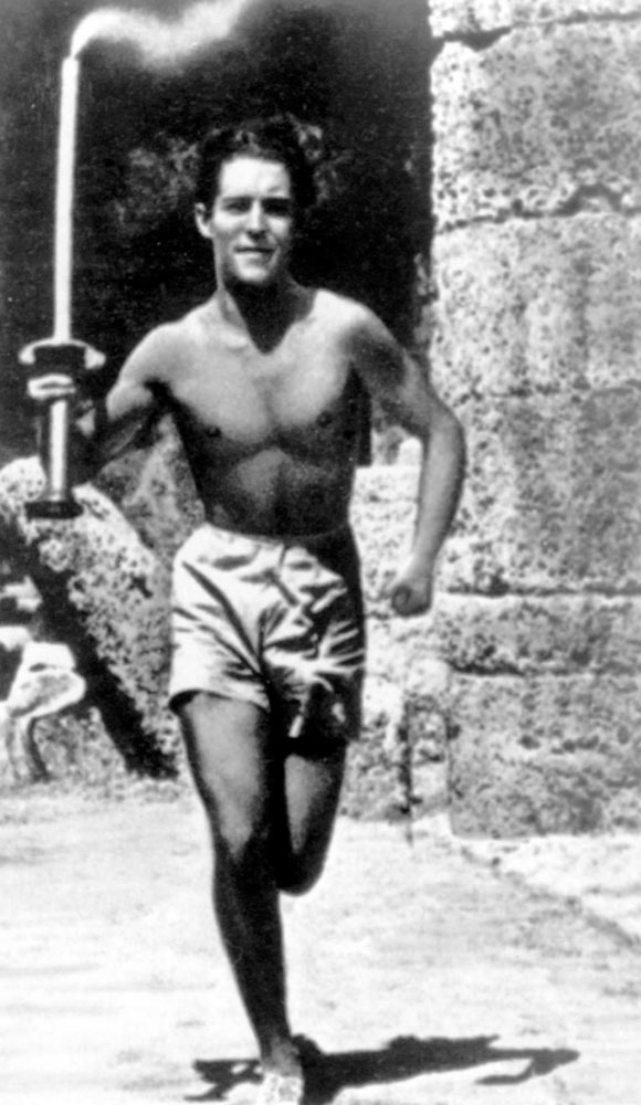 An athlete runs with the Olympic flame during the first Olympic torch relay, which was introduced at the Berlin 1936 Olympic Games. The modern convention of moving the Olympic Flame via a relay system from Greece to the Olympic venue began in 1936. In photos: Olympic Games over the years