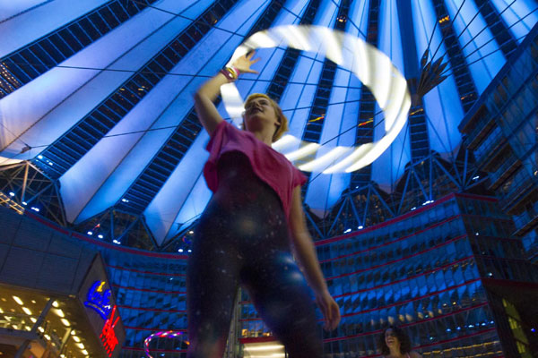 Women twirl LED-lit hula hoops in Berlin