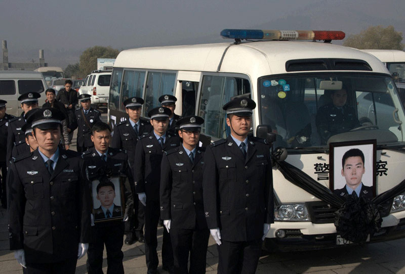 Comrade-in-arms attend the funeral of Huang Sheng who was stabbed to death after being attacked by armed criminals. Heroes of 2012