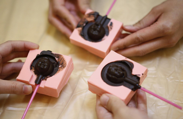 Participants display chocolates made in the shapes of their faces at a workshop ahead of Valentine's Day in Tokyo February 9, 2013. Personalized gifts for your Valentine