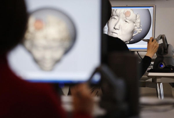 Participants who have received a full-body scan, edit their face data before sending them to a 3D printer during a workshop ahead of Valentine's Day at KS Design Lab in Tokyo February 2, 2013. Personalized gifts for your Valentine