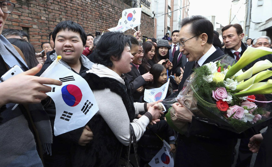A car (front C) carrying South Korea's outgoing President Lee Myung-bak S. Korea's first female president takes office