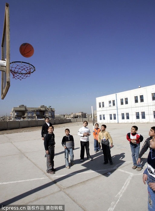Iraqi children play basketball at a school's playground in Baghdad, Feb 13, 2007. Public sports in post-war Iraq