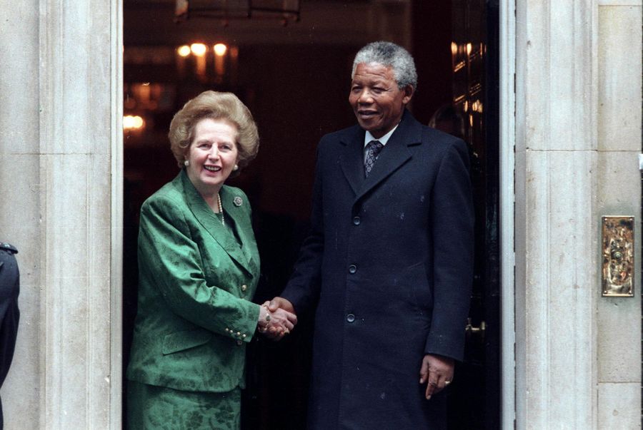 African National Congress leader Nelson Mandela (R) is greeted by British Prime Minister Margarat Thatcher prior to their talks, at 10 Downing Street in this July 4, 1990 file photo. Margaret Thatcher with politicians