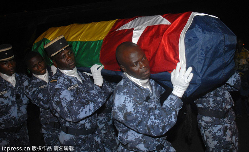 Togolese gendarmes carry the coffin wrapped in the national flag for one of the victims killed in an attack that claimed the lives of two members of the Togolese national football team, on Jan 8, 2010 Attacks and threats affected sporting events in history