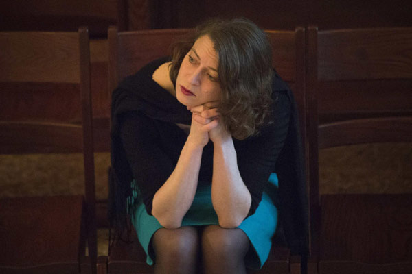 A woman sits during an interfaith prayer service remembering the victims of the Boston Marathon bombings at the Paulist Center in Boston, Massachusetts April 16, 2013. Boston mourns bombing victims
