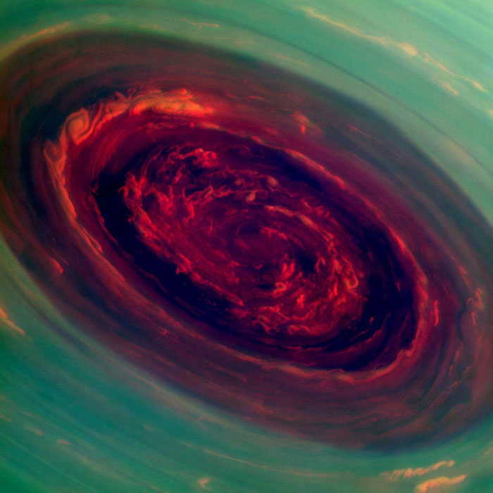 The spinning vortex of Saturn's north polar storm resembles a rose surrounded by green foliage in this false-color handout image from NASA's Cassini spacecraft taken Nov 27, 2012. NASA handout photos of Saturn storm and galaxies