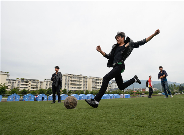 High-school students in Tianquan county, Sichuan province, enjoy a soccer match on May 3, 2013. Sport of joy and hope