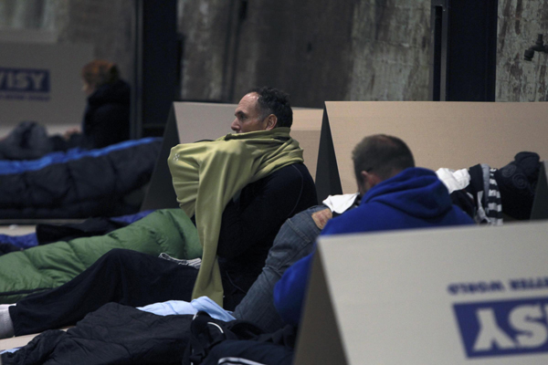 Business chiefs spend a cold winter night in a dilapidated factory as they join CEO Sleepout 2013, an activity to draw attention to the needs of homeless people, in Sydney, Australia, on June 20, 2013. CEOs join the homeless in Australia