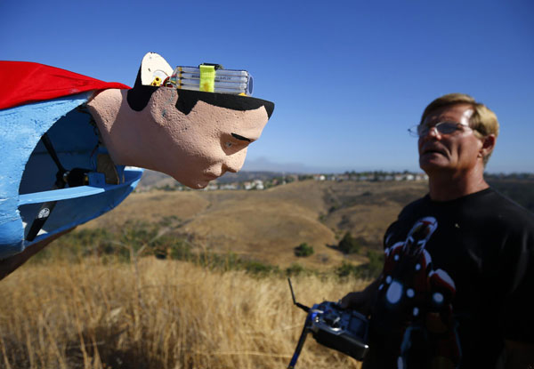 A radio-controlled Superman plane is flown by designer Otto Dieffenbach during a test flight in San Diego, California June 27, 2013. It's a bird, it's a Superman plane