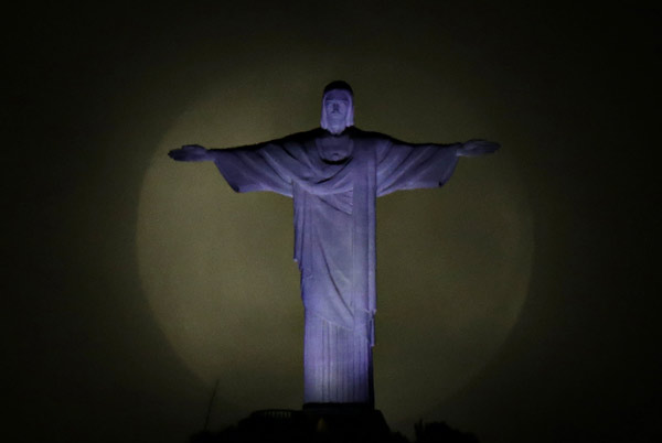 Big moon pictured with Christ the Redeemer statue