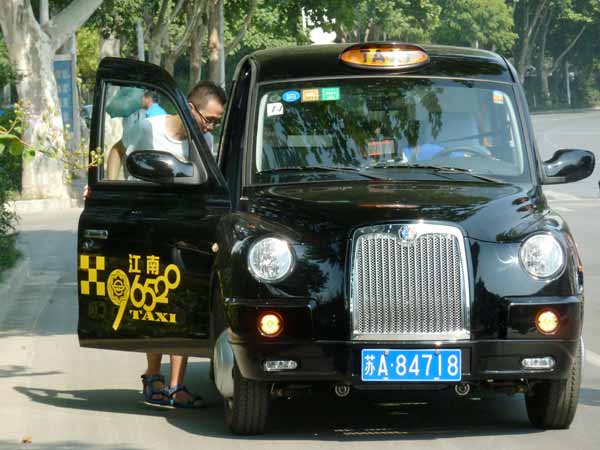 Classic British taxi cabs on road in E China