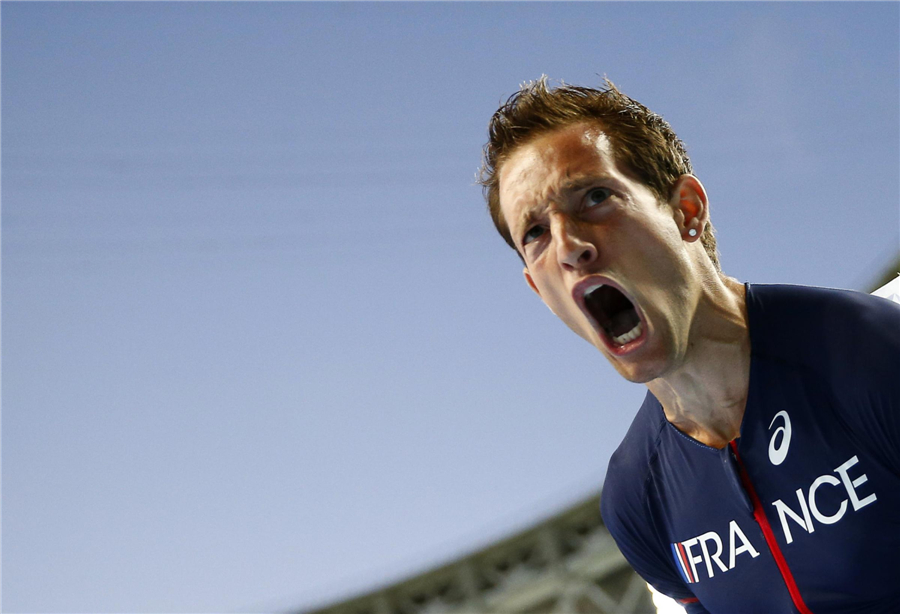 Renaud Lavillenie of France celebrates after finishing second in the men's pole vault final during the IAAF World Athletics Faces of triumph and defeat at athletics worlds