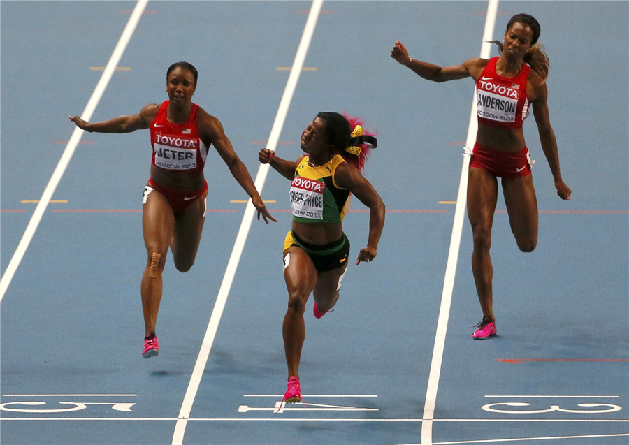 Shelly-Ann Fraser-Pryce (C) of Jamaica crosses the finish line to win the women's 100 metres final Faces of triumph and defeat at athletics worlds