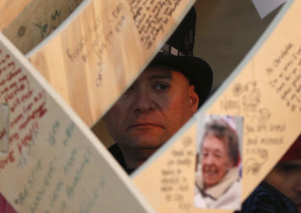 Jason Teplitsky looks at messages left by participants at sunrise at the Temple of Whollyness during the Burning Man 2013 arts and music festival in the Black Rock Desert of Nevada, Aug 31, 2013. Burning Man arts and music festival in Nevada