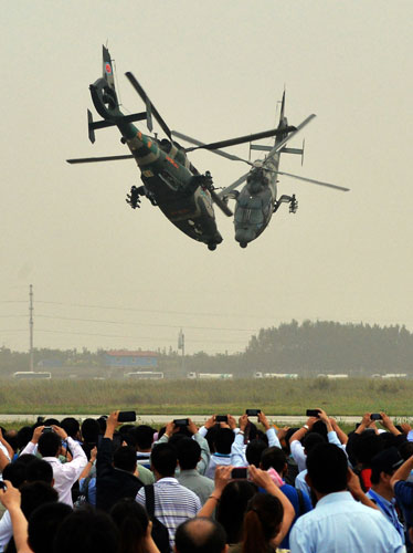 Helicopters practice acrobatic moves for expo
