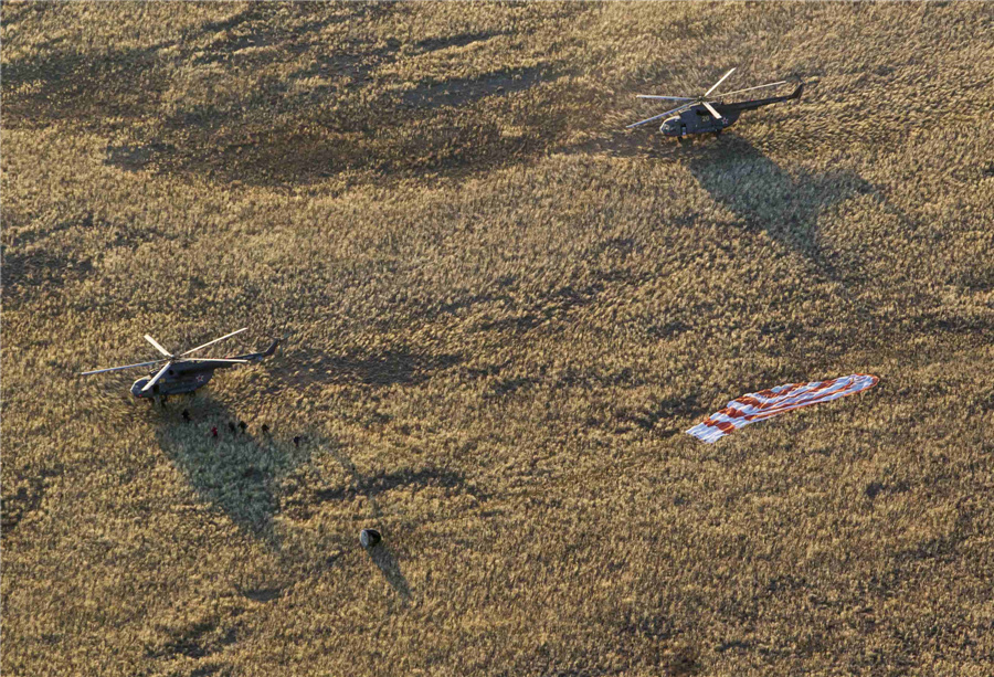 Intl space crew returns Olympic torch to Earth